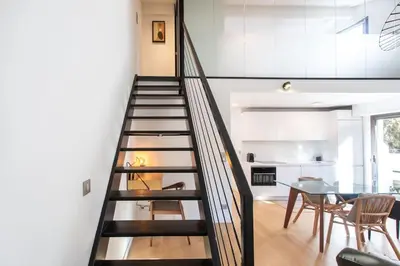 a staircase in a house with a dining room and a table at #11 Alex suite terrace parking AC 2 BDR 5mins to sea in Saint-Jean-Cap-Ferrat
