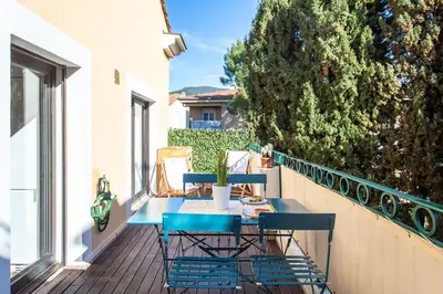 a patio with a table and chairs on a balcony at #11 Alex suite terrace parking AC 2 BDR 5mins to sea in Saint-Jean-Cap-Ferrat