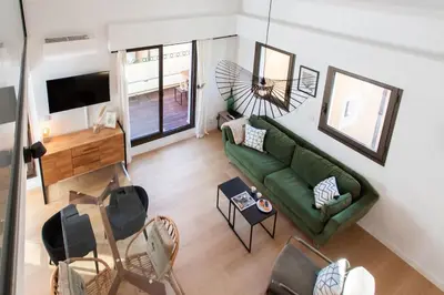 a living room with a green couch and chairs at #11 Alex suite terrace parking AC 2 BDR 5mins to sea in Saint-Jean-Cap-Ferrat