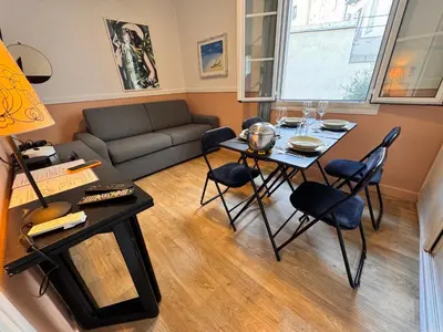 a living room with a table and chairs and a couch at Peaceful Flat w WiFi Very Close to Pl Massena Refurbished in Nice