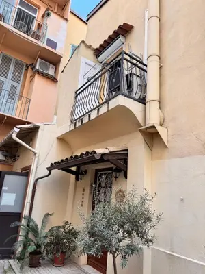 an apartment building with a balcony and plants at Peaceful Flat w WiFi Very Close to Pl Massena Refurbished in Nice
