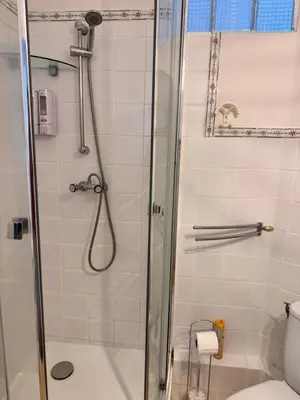 a shower with a glass door in a bathroom at Peaceful Flat w WiFi Very Close to Pl Massena Refurbished in Nice