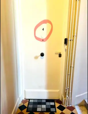 a room with a door with a clock on it at Sweet Home 1 ou Sweet Home 2 Réservez Sweet Home 1 ou Sweet Home 2 ou bien les deux in Nice
