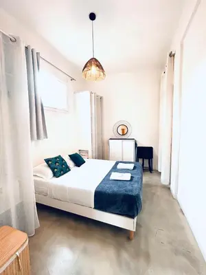 a white bedroom with a bed and a table at Sweet Home 1 ou Sweet Home 2 Réservez Sweet Home 1 ou Sweet Home 2 ou bien les deux in Nice