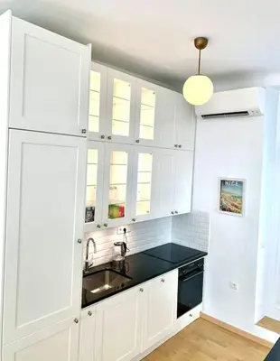 a kitchen with white cabinets and a sink at Saint Philippe - T3 près de la plage in Nice
