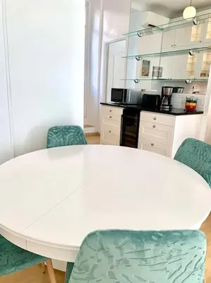 a white table and chairs in a kitchen at Saint Philippe - T3 près de la plage in Nice