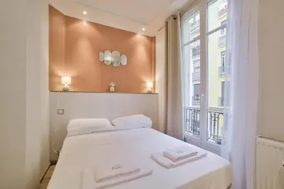 a bedroom with a bed with two towels on it at 12 Trachel - T2 lumineux au coeur de Nice in Nice