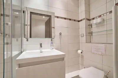 a bathroom with a sink and a toilet and a mirror at 12 Trachel - T2 lumineux au coeur de Nice in Nice