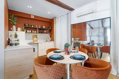a kitchen and dining room with a table and chairs at Nice Renting - 9b Massena - Chic Escape in the Heart of Nice Comfort & Charm ! in Nice
