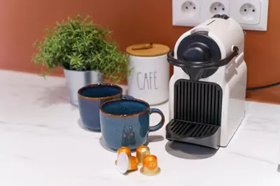a coffee maker and three cups on a counter at Nice Renting - 9b Massena - Chic Escape in the Heart of Nice Comfort & Charm ! in Nice