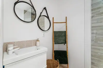 a bathroom with a sink and a mirror at Nice Renting - 9b Massena - Chic Escape in the Heart of Nice Comfort & Charm ! in Nice
