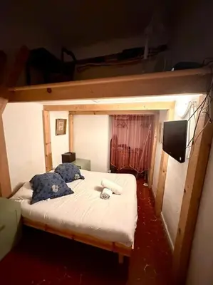 a bedroom with a bunk bed with a tv on it at Abbaye - Appartement spacieux au coeur du Vieux-Nice in Nice