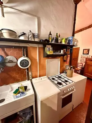 a kitchen with a stove and a white stove top oven at Abbaye - Appartement spacieux au coeur du Vieux-Nice in Nice