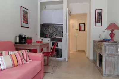 a living room with a couch and a table at Ratti - Studio avec jardin au coeur de Nice in Nice
