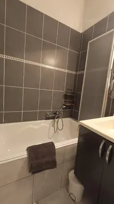 a bathroom with a bath tub with a towel on it at Appartement quartier Libération in Nice