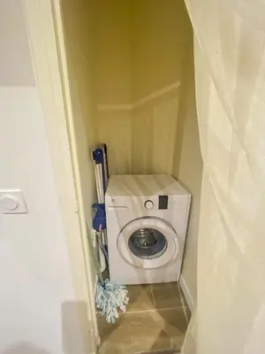 a small bathroom with a washing machine in a room at Alsace Lorraine - Wifi, 3 pers, hyper centre in Nice