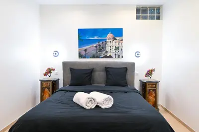 a bedroom with a bed with two towels on it at Grand loft à deux pas de la mer n1 in Nice