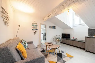 a living room with a couch and a table at Quiet 1 Bdr at Nice Port in Nice