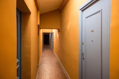 an empty hallway with orange walls and a corridorngth at Quiet 1 Bdr at Nice Port in Nice