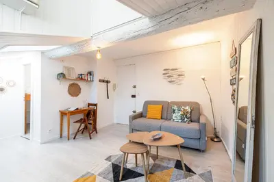 a living room with a couch and a table at Quiet 1 Bdr at Nice Port in Nice