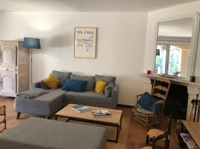 a living room with a couch and a table at Villa de Charme au coeur du Cap-Ferrat in Saint-Jean-Cap-Ferrat