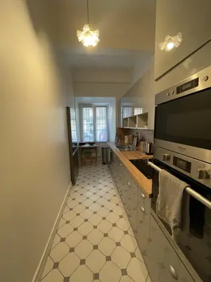 a kitchen with a sink and a stove top oven at Appartement à 1 min de la plage in Nice