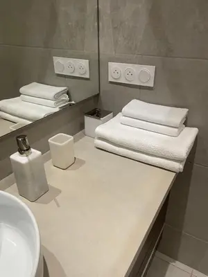 a bathroom with two beds and a sink at Appartement à 1 min de la plage in Nice