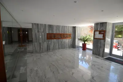 a lobby with a concrete wall and a potted plant at SIRIUS - Exceptionnelle vue mer dans les hauteurs de Nice in Nice