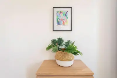 a plant in a white pot sitting on a table at #21 2 Bdr balconies 10 mins walk to sea 5mins to tram in Nice