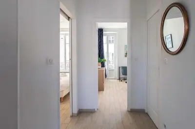 a hallway with a mirror and a room with a bed at #21 2 Bdr balconies 10 mins walk to sea 5mins to tram in Nice