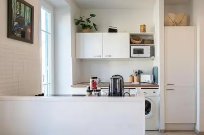 a kitchen with white cabinets and a counter top at #21 2 Bdr balconies 10 mins walk to sea 5mins to tram in Nice