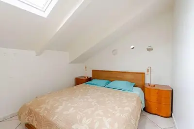 a bed with two blue pillows in a bedroom at 2P Carré d'Or, Nice hypercentre in Nice