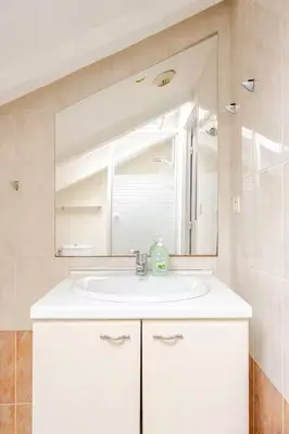 a bathroom with a white sink and a mirror at 2P Carré d'Or, Nice hypercentre in Nice