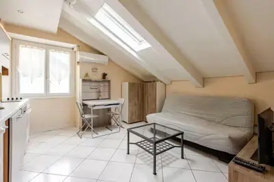 a bedroom with a bed and a table in a room at 2P Carré d'Or, Nice hypercentre in Nice