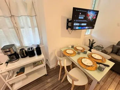 a living room with a table with plates of food on it at Carre D'or: Very Central Calm Cozy 2BR, with Wi-Fi in Nice