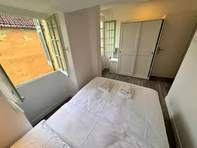a bedroom with a bed in a room with a window at Carre D'or: Very Central Calm Cozy 2BR, with Wi-Fi in Nice