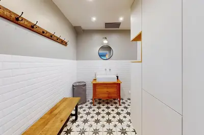 a bathroom with a sink and a wooden bench at Villa La Roche aux Mouettes FSHH in Nice