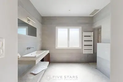 a bathroom with a sink and a tub and a window at Villa La Roche aux Mouettes FSHH in Nice