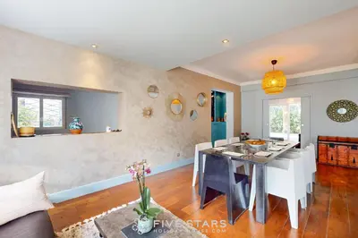 a kitchen and living room with a dining room table at Villa La Roche aux Mouettes FSHH in Nice