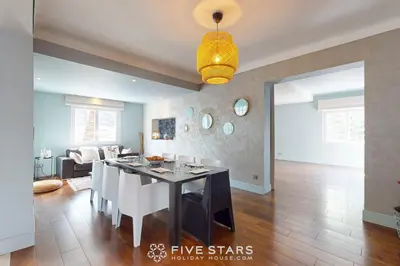 a dining room and living room with a dining table at Villa La Roche aux Mouettes FSHH in Nice