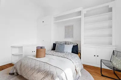 a bedroom with a bed with white walls at Nice Renting - FOCH - Luxury Bourgeois & Design at the Heart of Nice in Nice