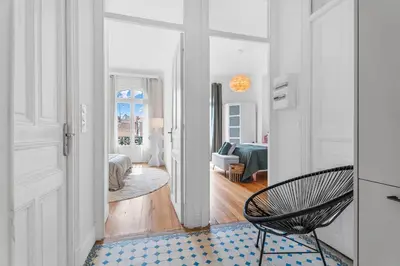 a room with a hallway with a chair and a living room at Nice Renting - FOCH - Luxury Bourgeois & Design at the Heart of Nice in Nice