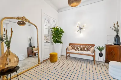 a living room with a bench and a mirror at Nice Renting - FOCH - Luxury Bourgeois & Design at the Heart of Nice in Nice