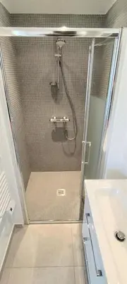 a shower with a glass door in a bathroom at 2p bas de Villa avec Jacuzzi privatif proche de Nice in Saint-Laurent-du-Var