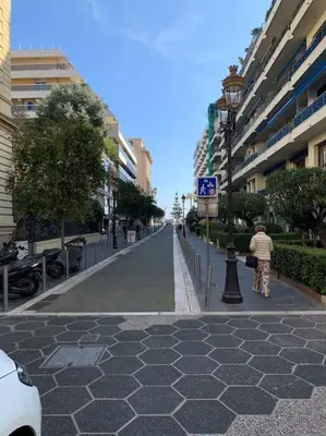 a person standing on a street in a city at ZEN & COSY - CARRÉ d'OR - Hyper centre - Plage in Nice