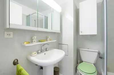 a bathroom with a sink and a toilet and a mirror at Nice Absea Belles Terres C in Nice