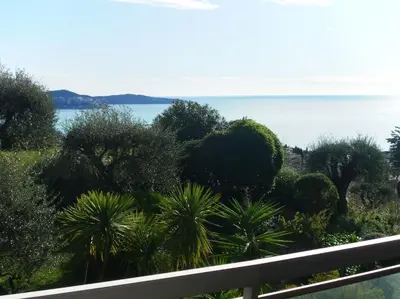 a view of trees and the ocean from a balcony at Nice Absea Belles Terres C in Nice
