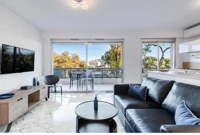 a living room with a couch and a table at Nice Absea Belles Terres in Nice