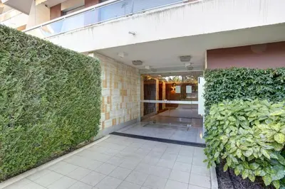 a hallway of a building with a green hedge at Nice Absea Belles Terres 5 in Nice