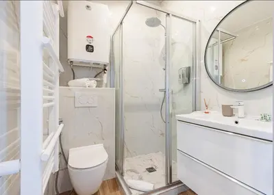 a bathroom with a shower and a toilet and a sink at Beau studio cozy centre ville et plages n13 in Nice
